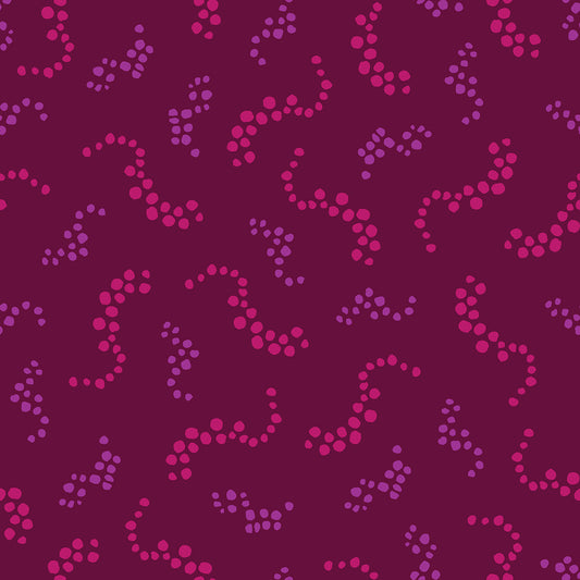 Beach Breezes Plum features a repeating pattern in plum, red, and purple colors of swirling dots reminiscent of sea spray on ocean waves.